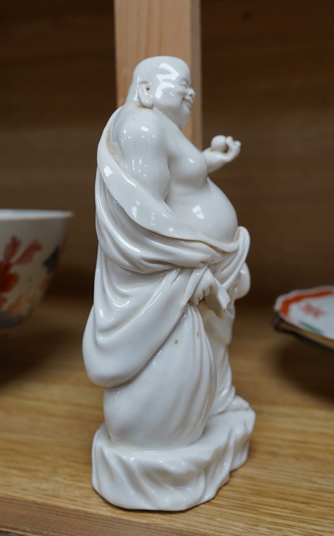 A Chinese blanc de chine figure of Budai, 18cm high. Condition - fair to good.